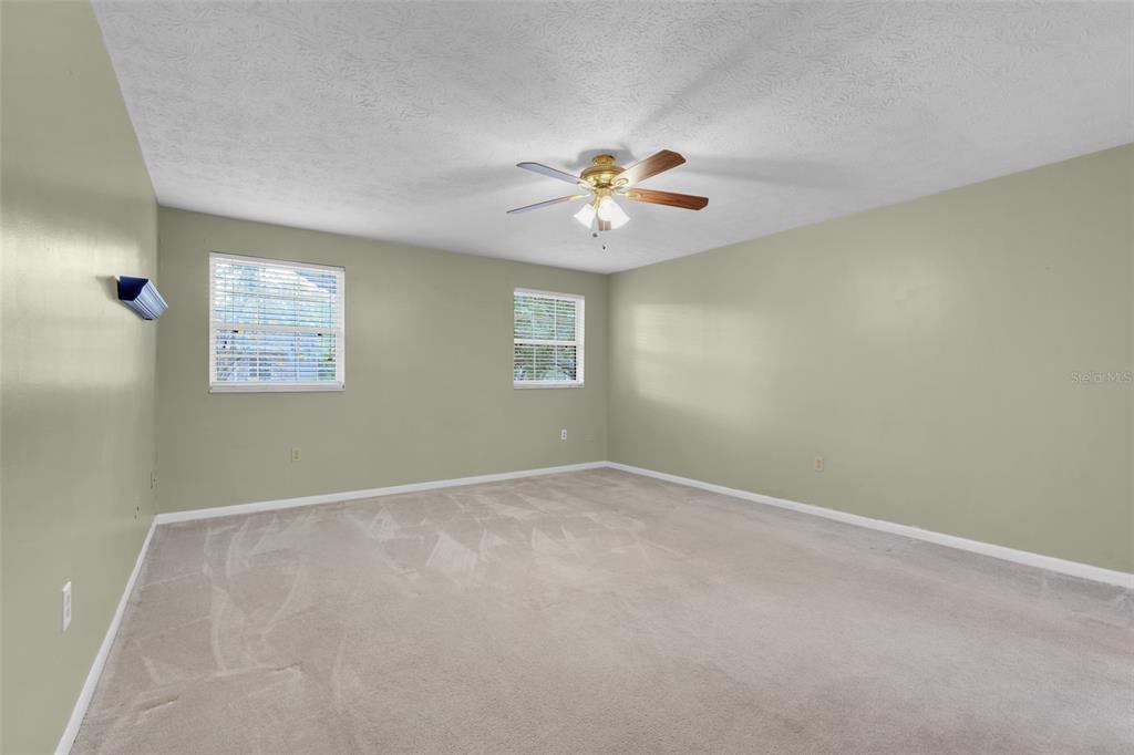 4224 Lake Underhill Road, Unit 8B8 Orlando, FL 32803 - Photo 18 of 47 an empty room with windows and a chandelier fan