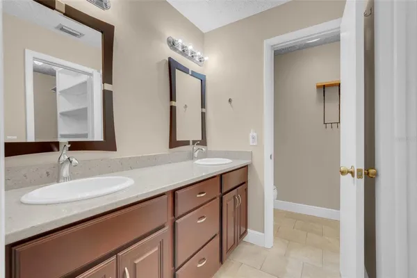 a bathroom with a granite countertop sink vanity and mirror