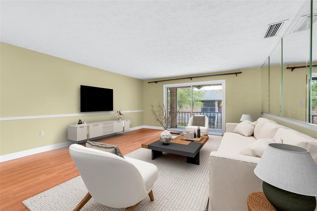 4224 Lake Underhill Road, Unit 8B8 Orlando, FL 32803 - Photo 2 of 47 a living room with furniture and a flat screen tv