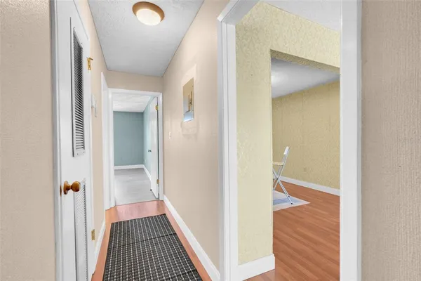 a view of a hallway with wooden floor