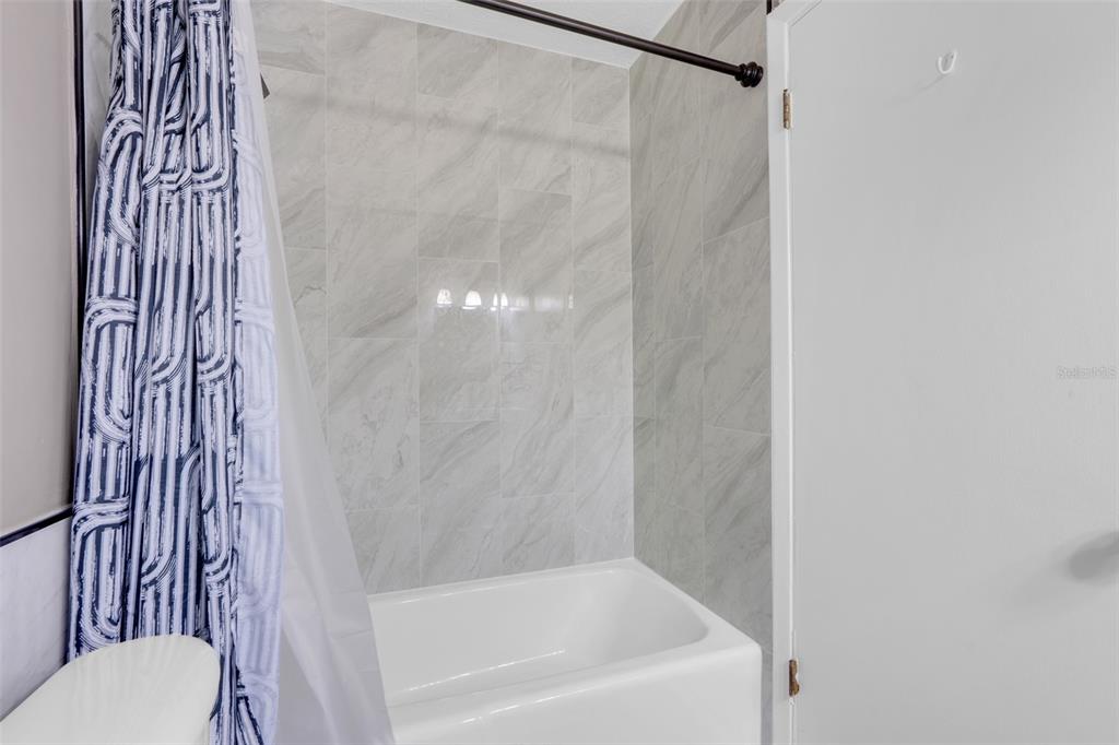 4224 Lake Underhill Road, Unit 8B8 Orlando, FL 32803 - Photo 28 of 47 a bathroom with a bathtub and a shower