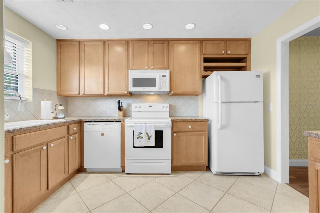 4224 Lake Underhill Road, Unit 8B8 Orlando, FL 32803 - Photo 3 of 47 a kitchen with stainless steel appliances a refrigerator sink and microwave