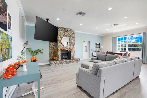 a living room with furniture fireplace and a flat screen tv