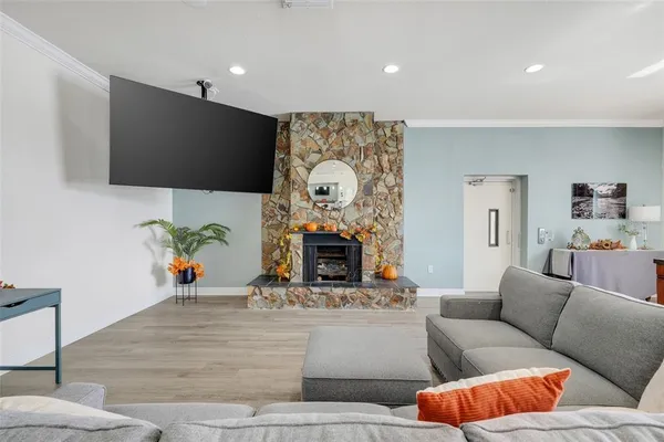 a living room with furniture a fireplace and a flat screen tv