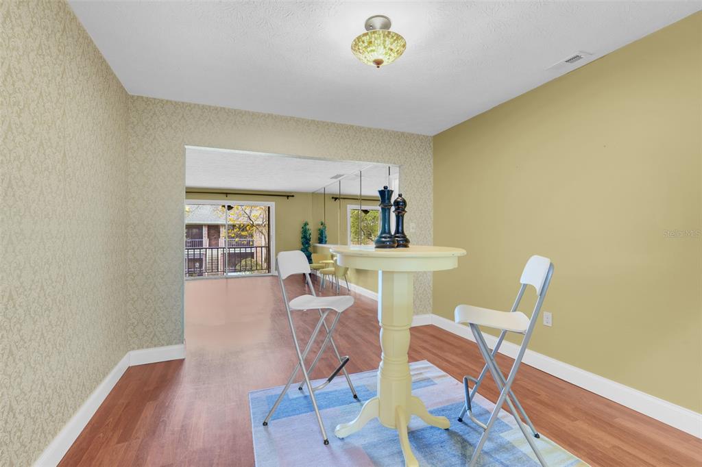 4224 Lake Underhill Road, Unit 8B8 Orlando, FL 32803 - Photo 4 of 47 a view of a dining room with furniture and wooden floor