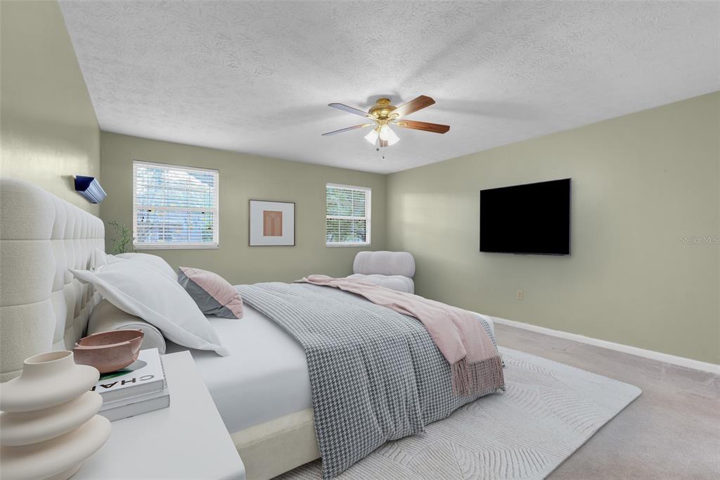 4224 Lake Underhill Road, Unit 8B8 Orlando, FL 32803 - Photo 5 of 47 a bedroom with a bed and a tv