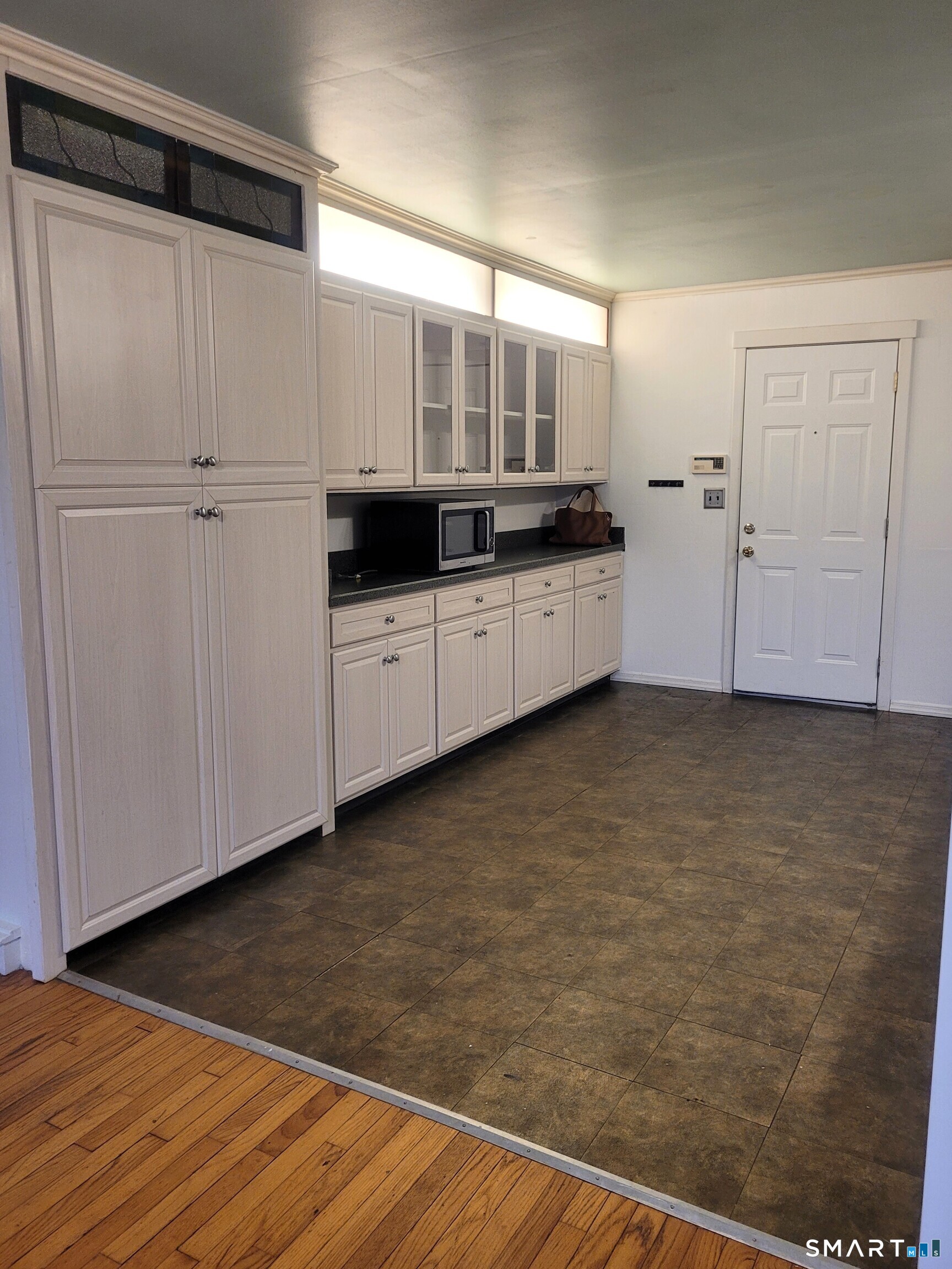 123 Bridge Street Groton, CT 06340 - Photo 5 of 22 a kitchen with cabinets and wooden floor