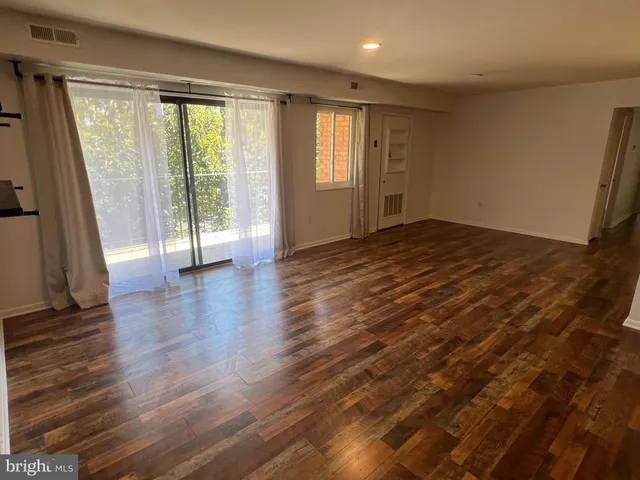 a view of kitchen with furniture and wooden floor