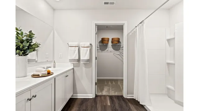 a storage room with wooden floor and cabinets