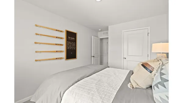 a bedroom with a bed and a lamp