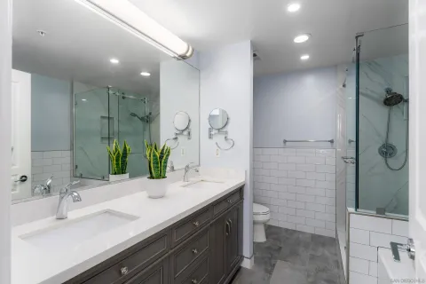 a bathroom with a double vanity sink mirror double and shower