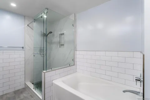 a bathroom with a bathtub and shower