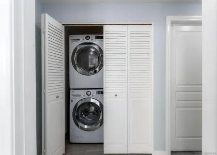a view of a hallway with washer and dryer