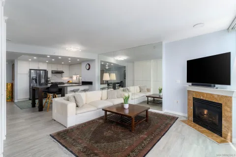 a living room with furniture a flat screen tv and a fireplace
