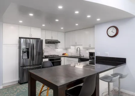 a kitchen with a refrigerator a stove a sink and a microwave