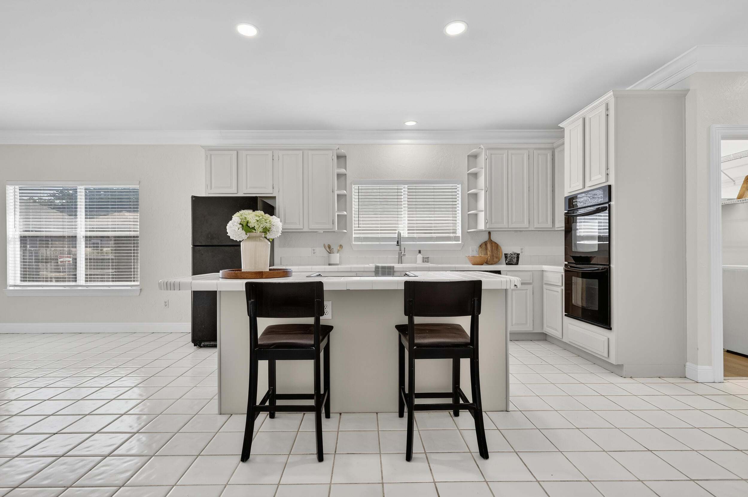 2805 Sam Snead Court Shalimar, FL 32579 - Photo 15 of 56 a kitchen with stainless steel appliances kitchen island granite countertop a dining table chairs and a refrigerator