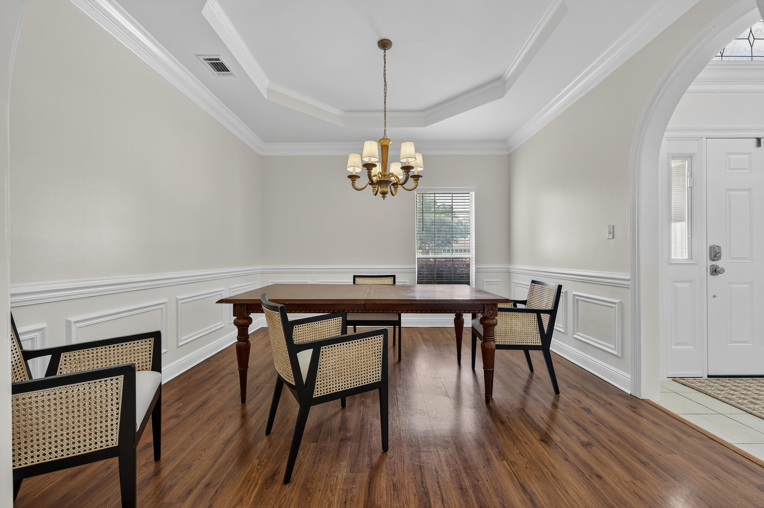 2805 Sam Snead Court Shalimar, FL 32579 - Photo 24 of 56 a dining room with wooden floor a chandelier a wooden table and chairs