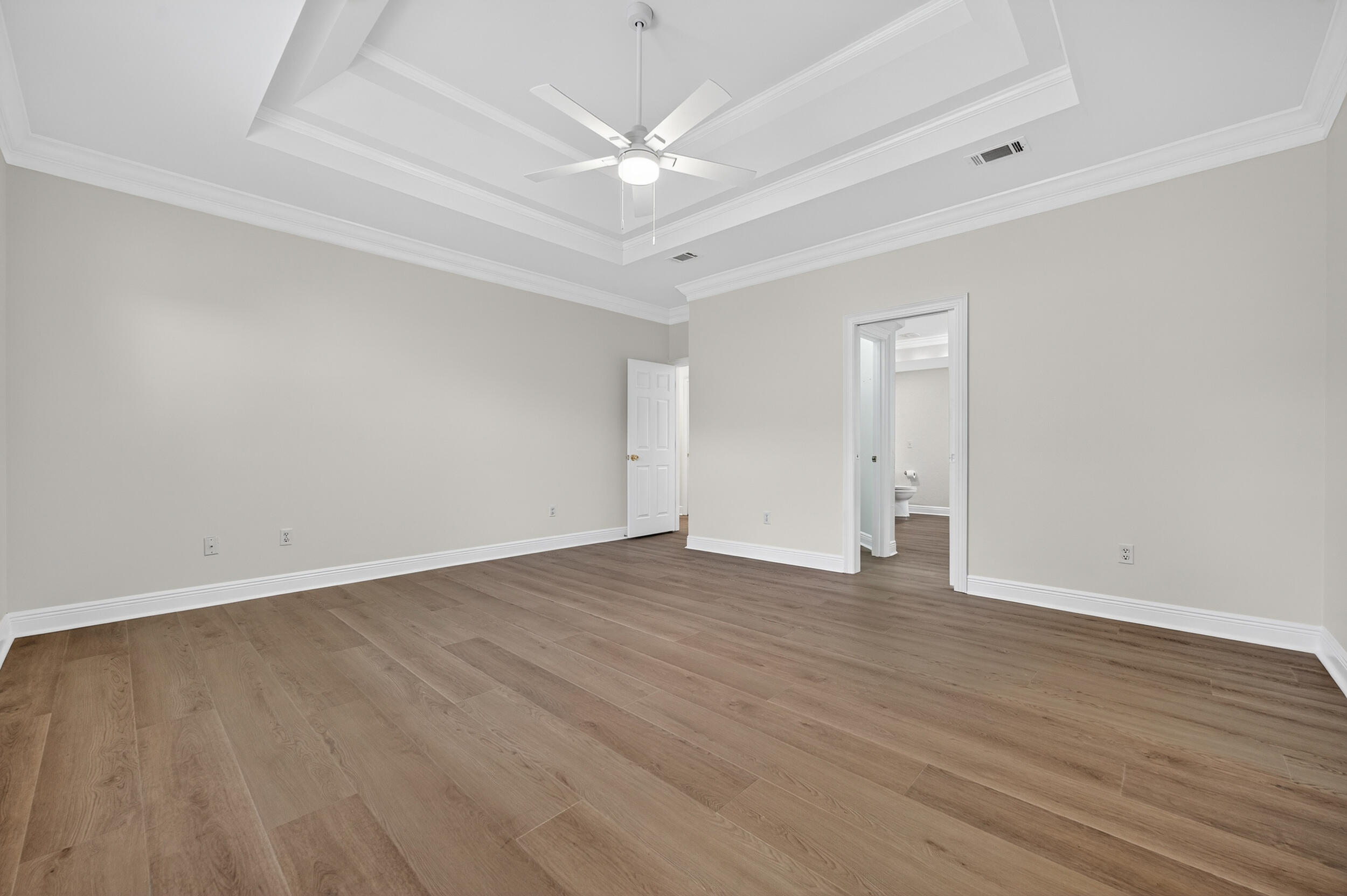 2805 Sam Snead Court Shalimar, FL 32579 - Photo 29 of 56 a view of an empty room with wooden floor and a ceiling fan