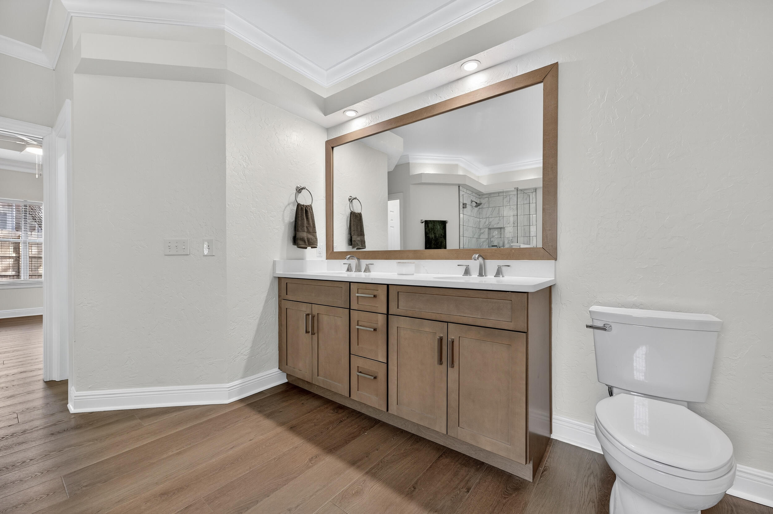 2805 Sam Snead Court Shalimar, FL 32579 - Photo 34 of 56 a spacious bathroom with a toilet a sink and mirror