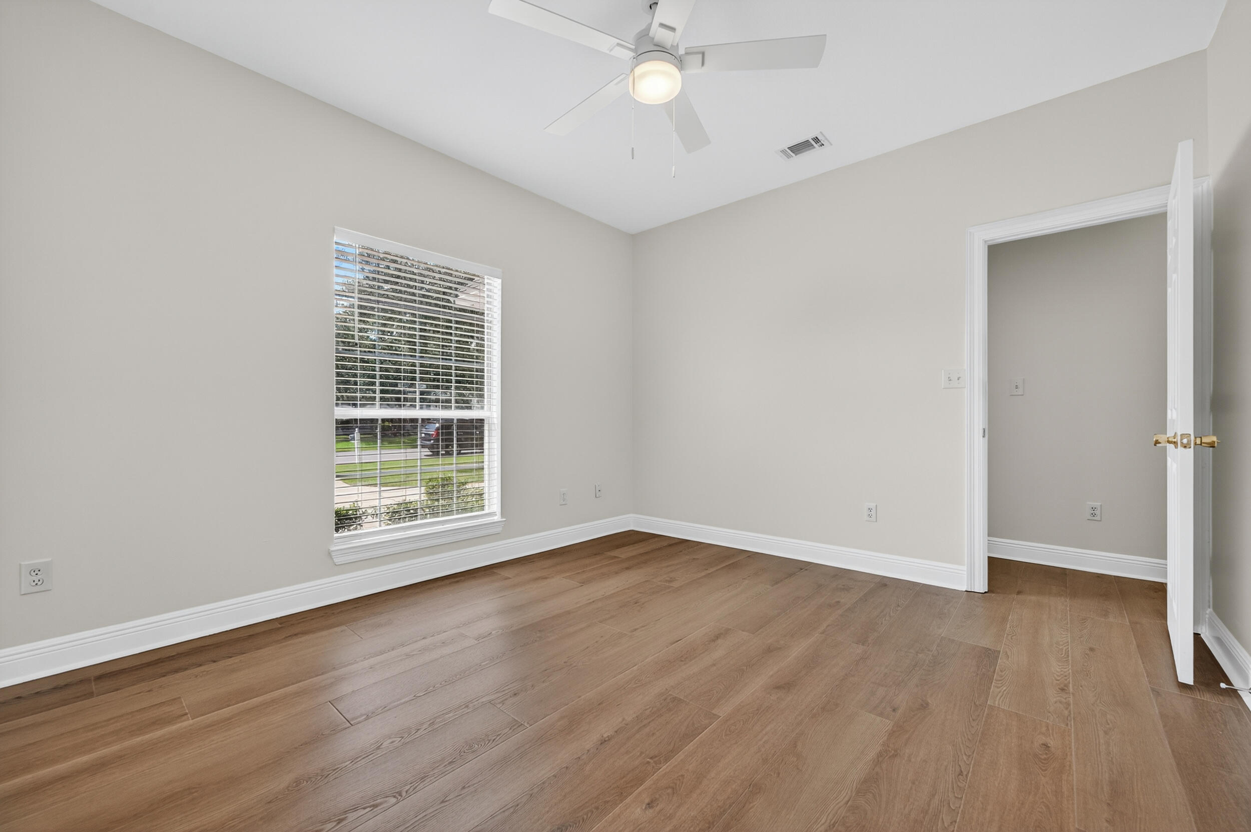 2805 Sam Snead Court Shalimar, FL 32579 - Photo 45 of 56 wooden floor in an empty room with a window
