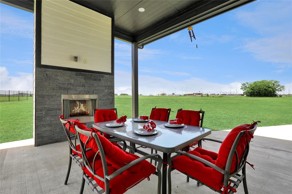 801 Lexington Lane Nevada, TX 75173 - Photo 27 of 40 View of patio featuring an outdoor stone fireplace and outdoor dining area