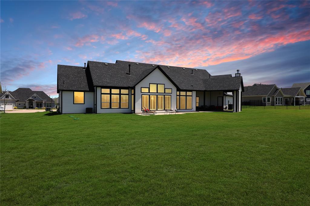 801 Lexington Lane Nevada, TX 75173 - Photo 29 of 40 Back of house featuring a patio, a lawn, and roof with shingles
