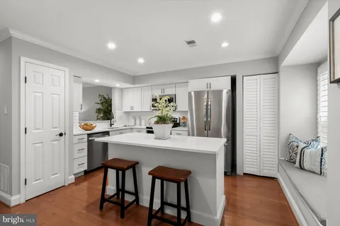a kitchen with refrigerator and cabinets