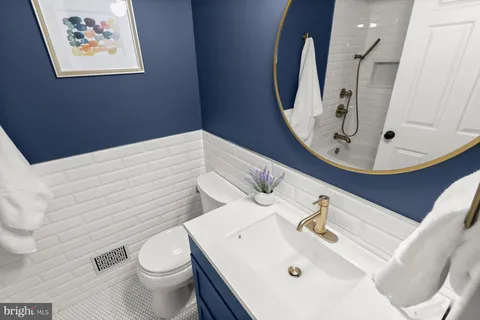 a bathroom with a toilet sink and mirror