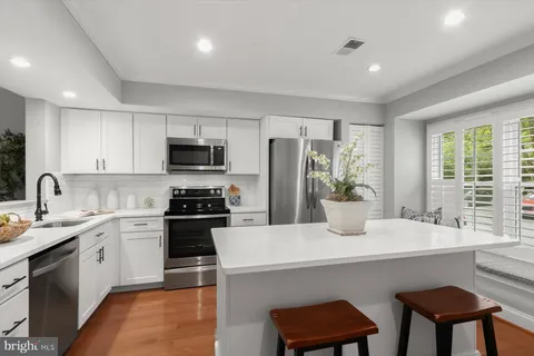 a kitchen with a stove a sink and a refrigerator