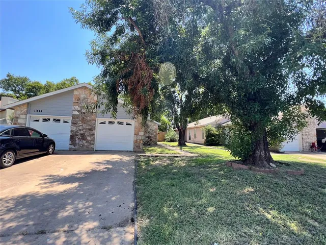 a yellow house with trees in front of it