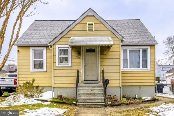 a view of a brick house with small yard
