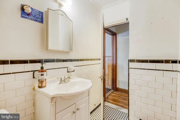a view of bathroom with a sink and mirror