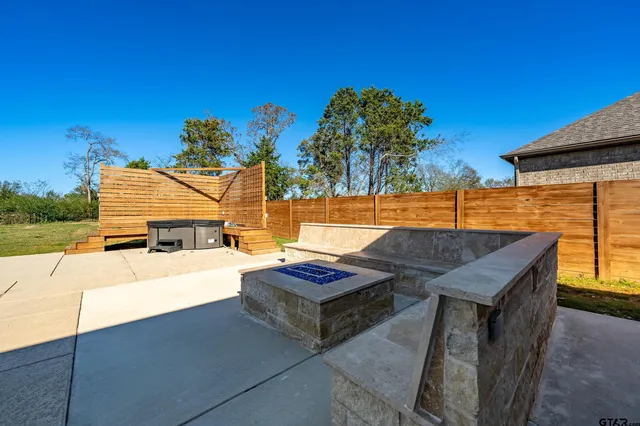 a view of a backyard with couches chair and table of the ocean