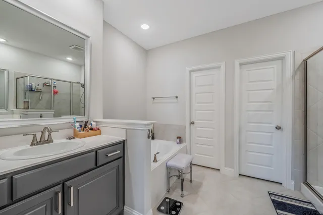 a bathroom with a sink vanity mirror and toilet