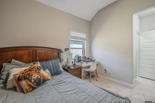 a bedroom with bed and a window