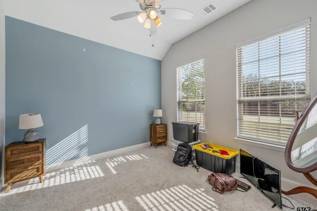 a bedroom with furniture and a window