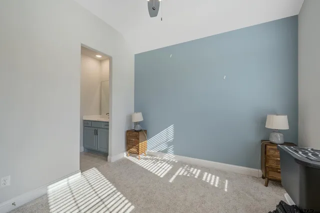 a bedroom with a bed and a table