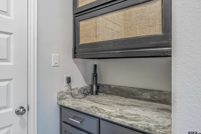 a bathroom with a granite countertop sink and a window