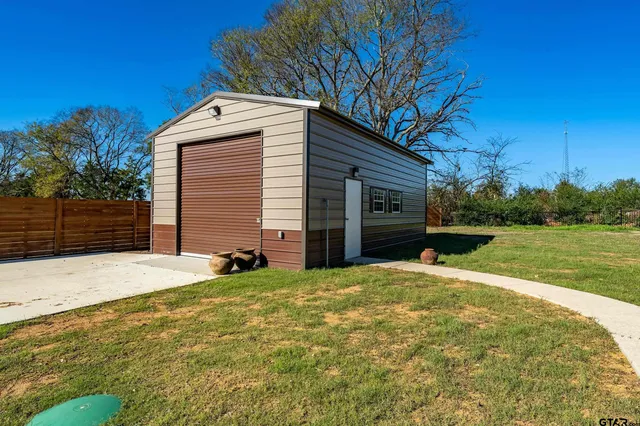 a view of a house with backyard and trees