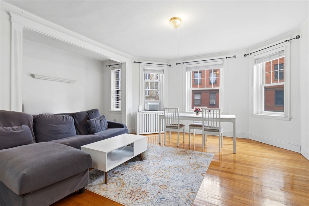 73 Parkman Street, Unit 1 Brookline, MA 02446 - Photo 1 of 10 a living room with furniture and a table