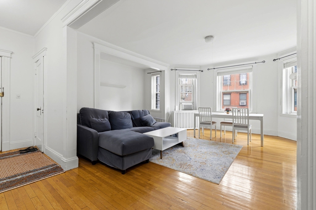73 Parkman Street, Unit 1 Brookline, MA 02446 - Photo 3 of 10 a living room with furniture and a wooden floor