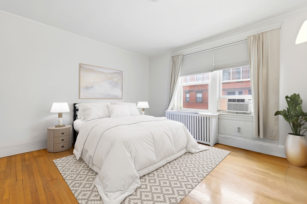 73 Parkman Street, Unit 1 Brookline, MA 02446 - Photo 4 of 10 a bedroom with a large bed and a window