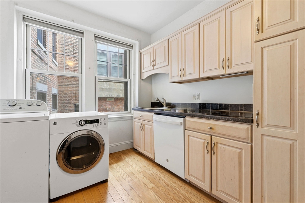 73 Parkman Street, Unit 1 Brookline, MA 02446 - Photo 6 of 10 a kitchen with white cabinets and sink