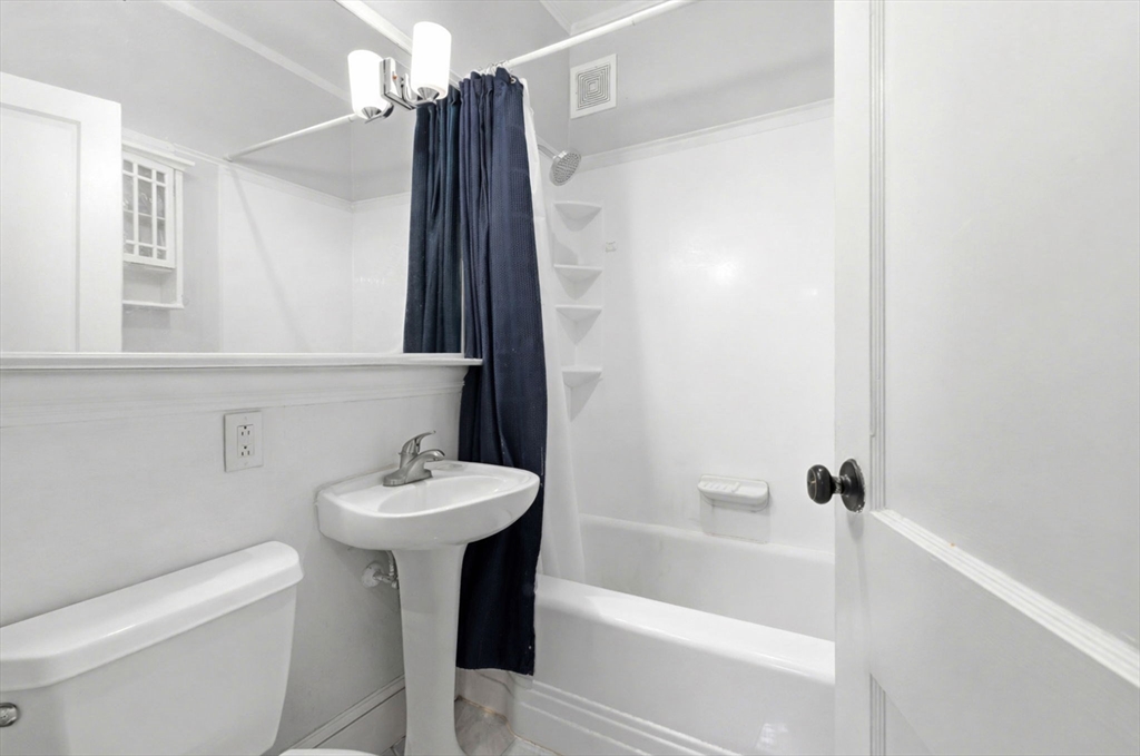 73 Parkman Street, Unit 1 Brookline, MA 02446 - Photo 7 of 10 a bathroom with a sink a toilet and shower