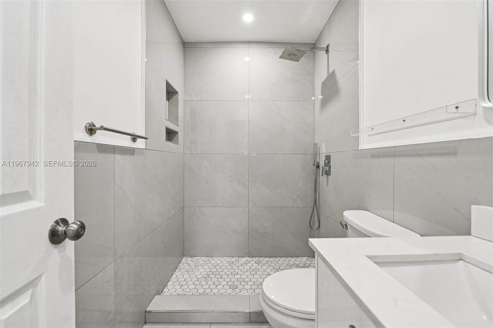 12237 Southwest 193rd Street Miami, FL 33177 - Photo 23 of 41 a bathroom with a sink a toilet and shower