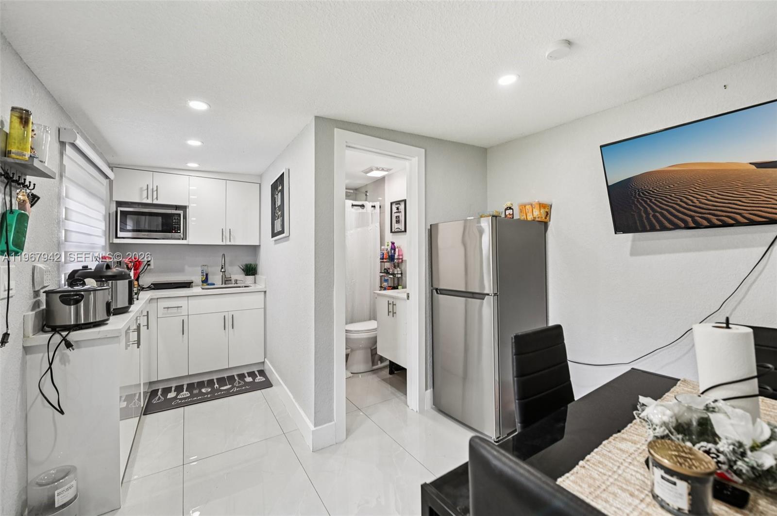 12237 Southwest 193rd Street Miami, FL 33177 - Photo 36 of 41 a kitchen with a refrigerator a stove top oven and a sink