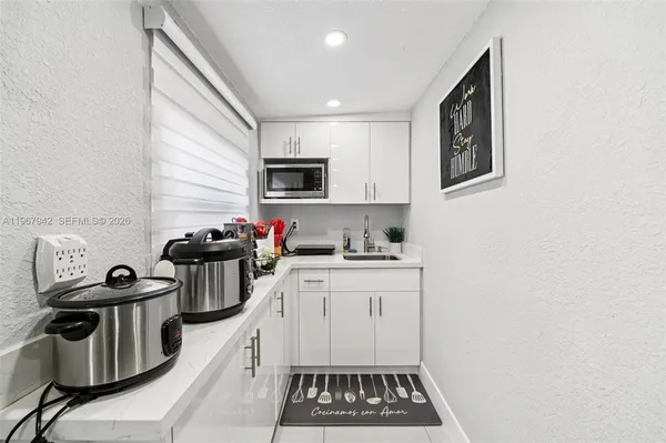 a bathroom with a sink a toilet and shower curtain