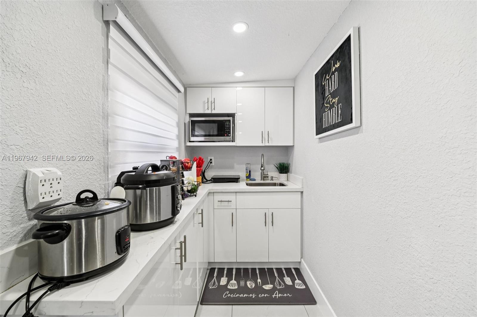 12237 Southwest 193rd Street Miami, FL 33177 - Photo 37 of 41 a kitchen that has a sink and a stove