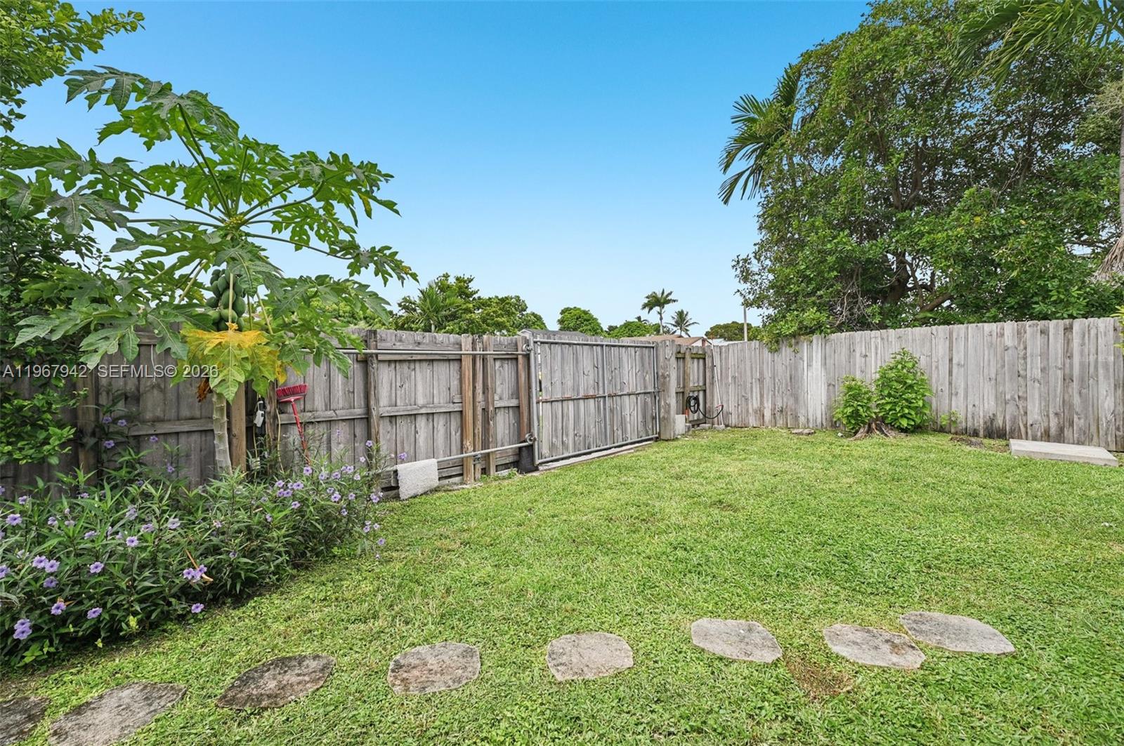 12237 Southwest 193rd Street Miami, FL 33177 - Photo 8 of 41 a garden with trees in the background