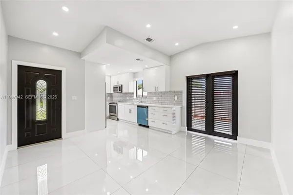 a view of a kitchen with stainless steel appliances cabinets